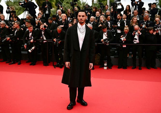 film horizontal celebrity full length arts culture and entertainment film industry celebrities international cannes film festival film festival cannes adult male man person clothing coat electronics camera photoshoot