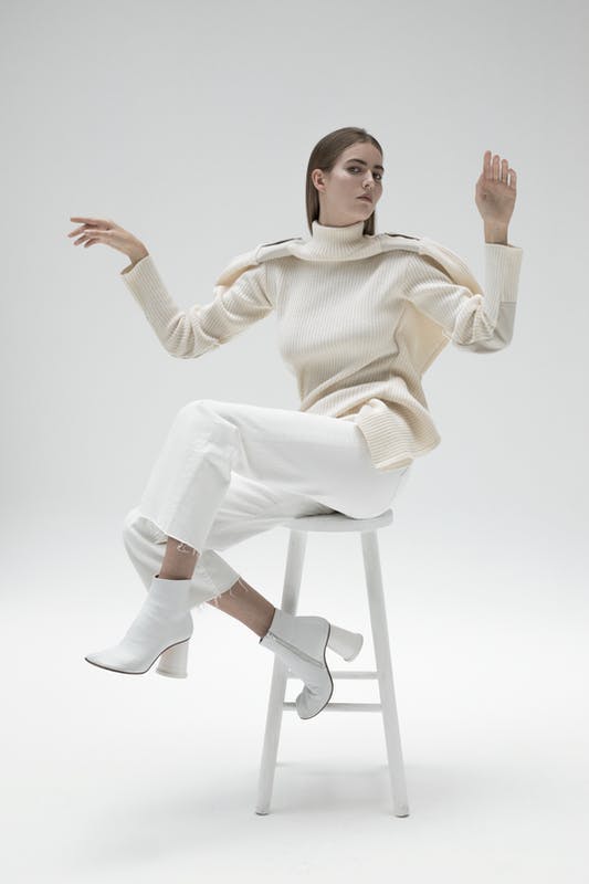 sleeve clothing apparel long sleeve sitting person human shoe footwear furniture