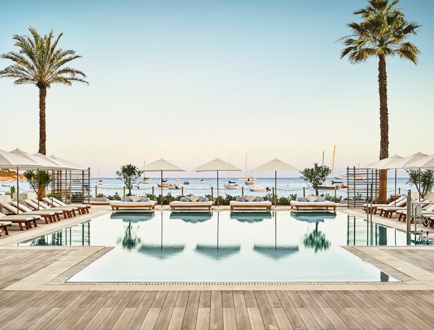 pool water building hotel resort palm tree plant arecaceae tree swimming pool