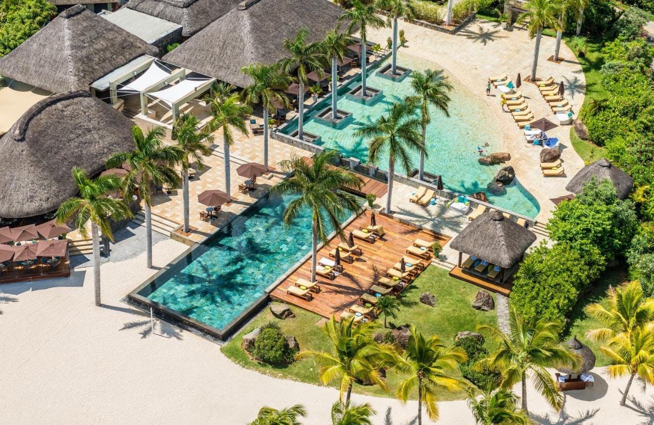 building hotel resort tree plant palm tree villa housing outdoors water