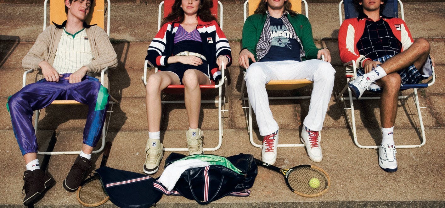 clothing apparel shoe footwear person chair furniture sitting tennis racket racket