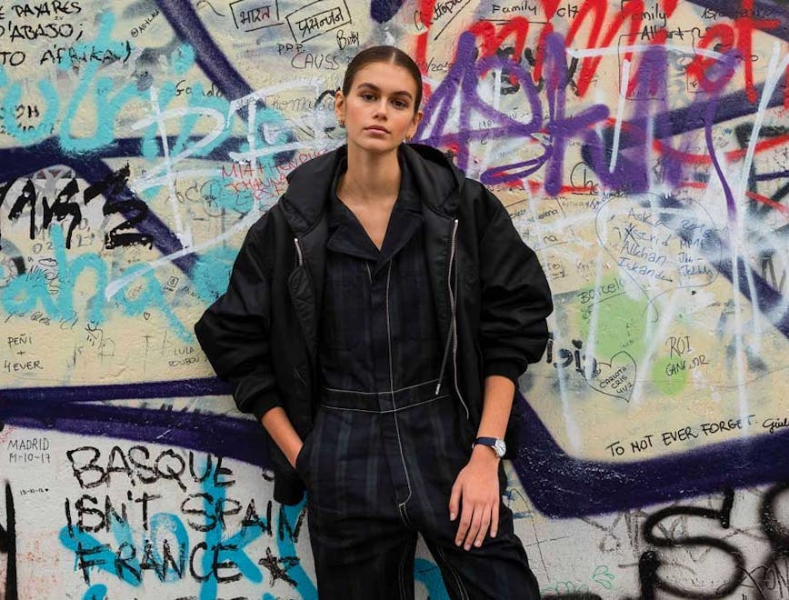 clothing apparel person graffiti wall wheel machine pants jacket coat
