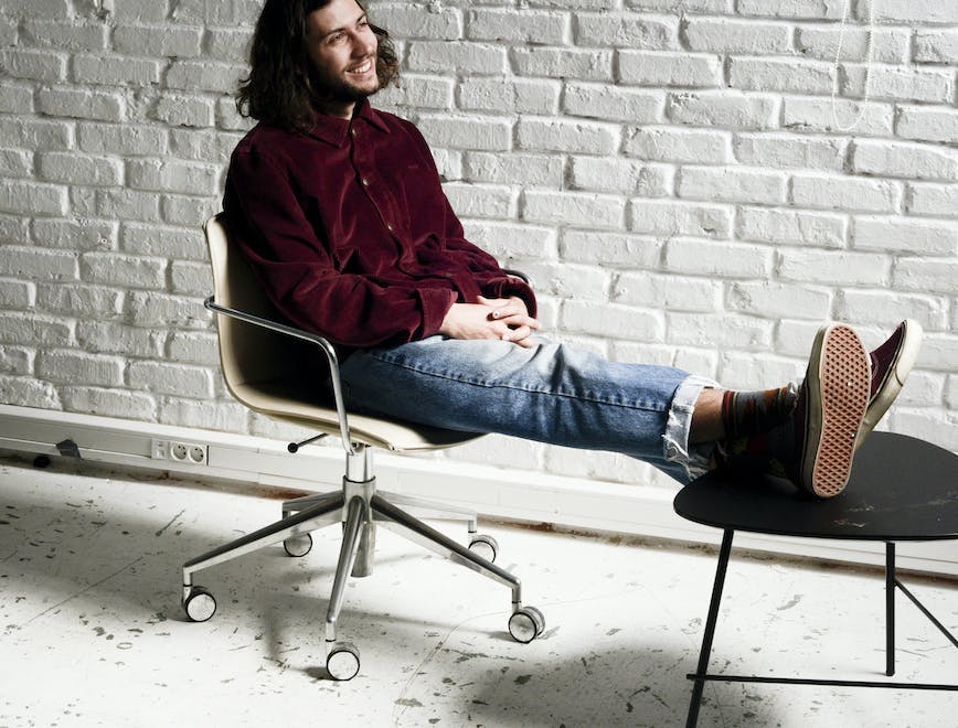 sitting person human clothing apparel footwear shoe furniture
