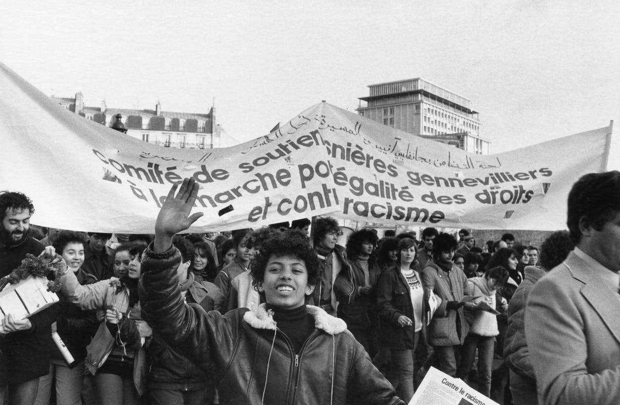 person human protest parade text crowd banner word