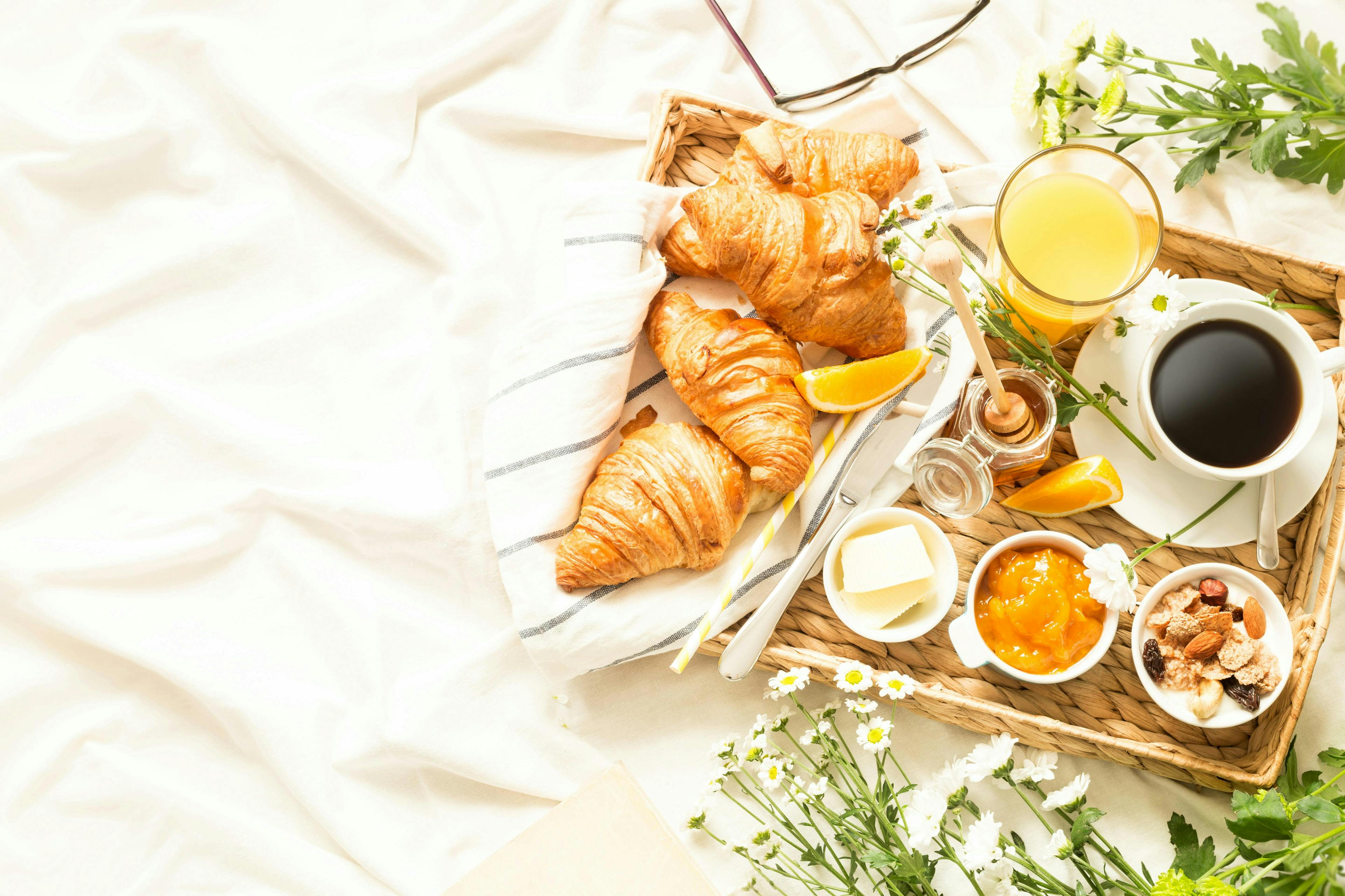 breakfast continental bed bedroom morning food eat drink beverage delicious tray meal coffee croissant orange juice flowers sheets white hotel b&b bed and breakfast background text space home lifestyle romantic country countryside rural rustic summer spring weekend holiday vacation scenery pension guesthouse relaxation menu relax calm beautiful fruits french jam leisure top view from above flat lay