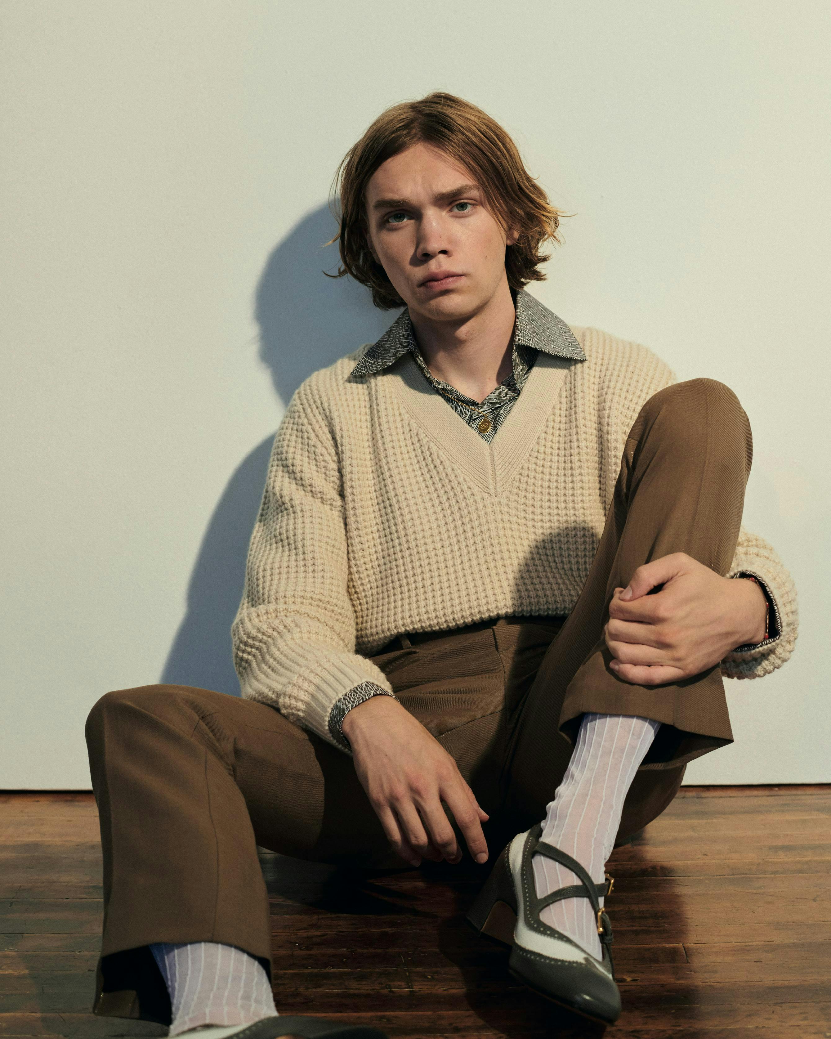 clothing apparel sweater person human footwear wood sleeve