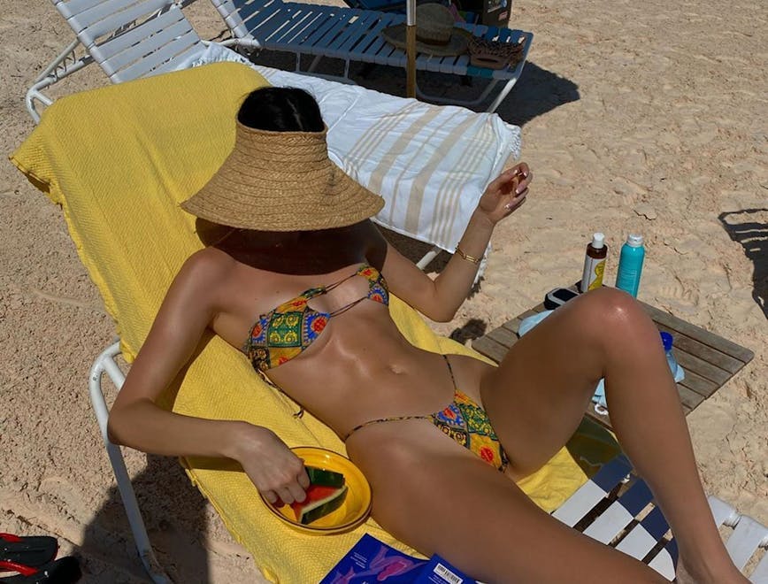 clothing apparel person human swimwear bikini back hat sun hat undershirt