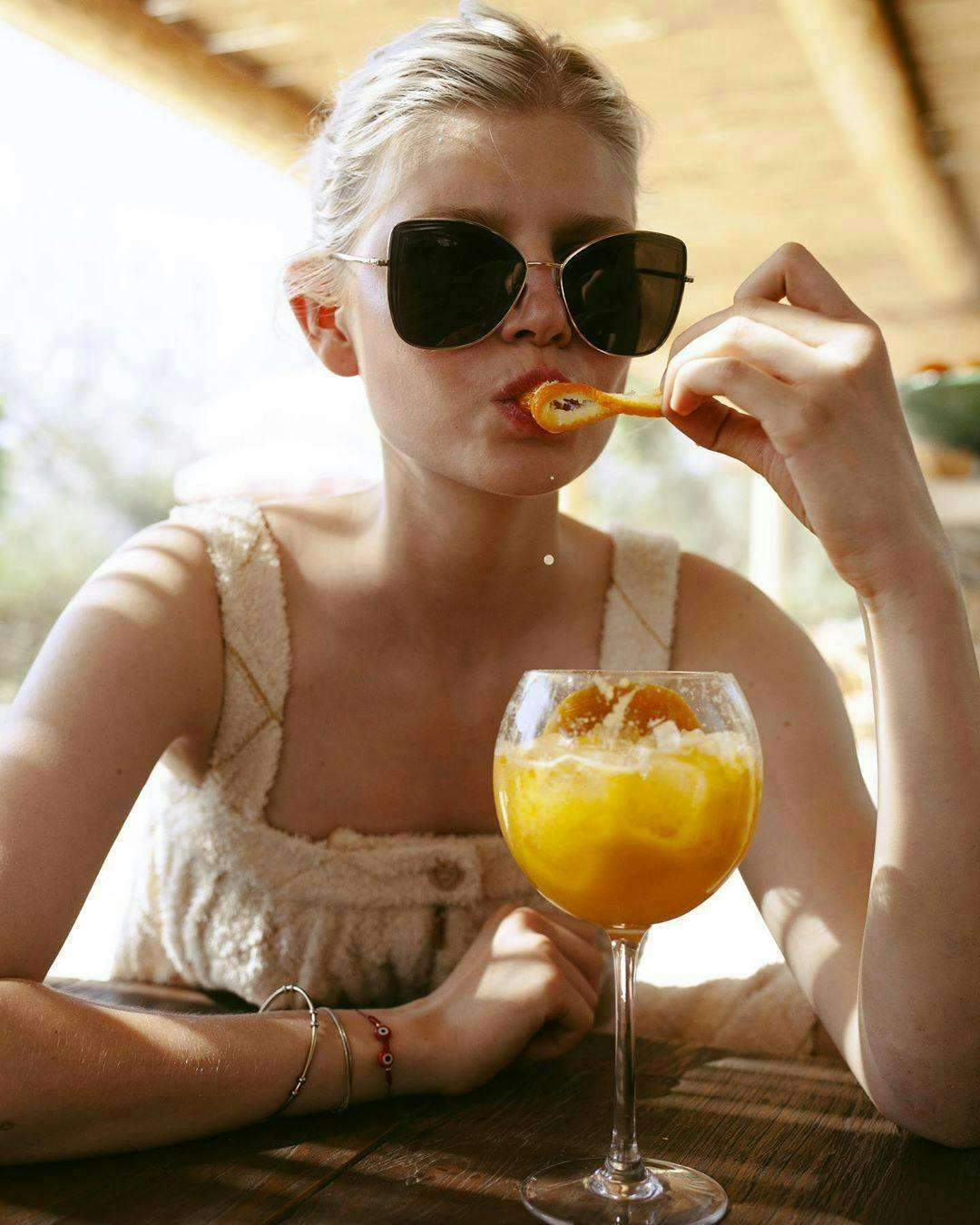 person human sunglasses accessories accessory juice beverage drink orange juice