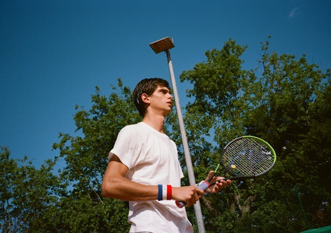 person human tennis racket racket sport sports clothing apparel