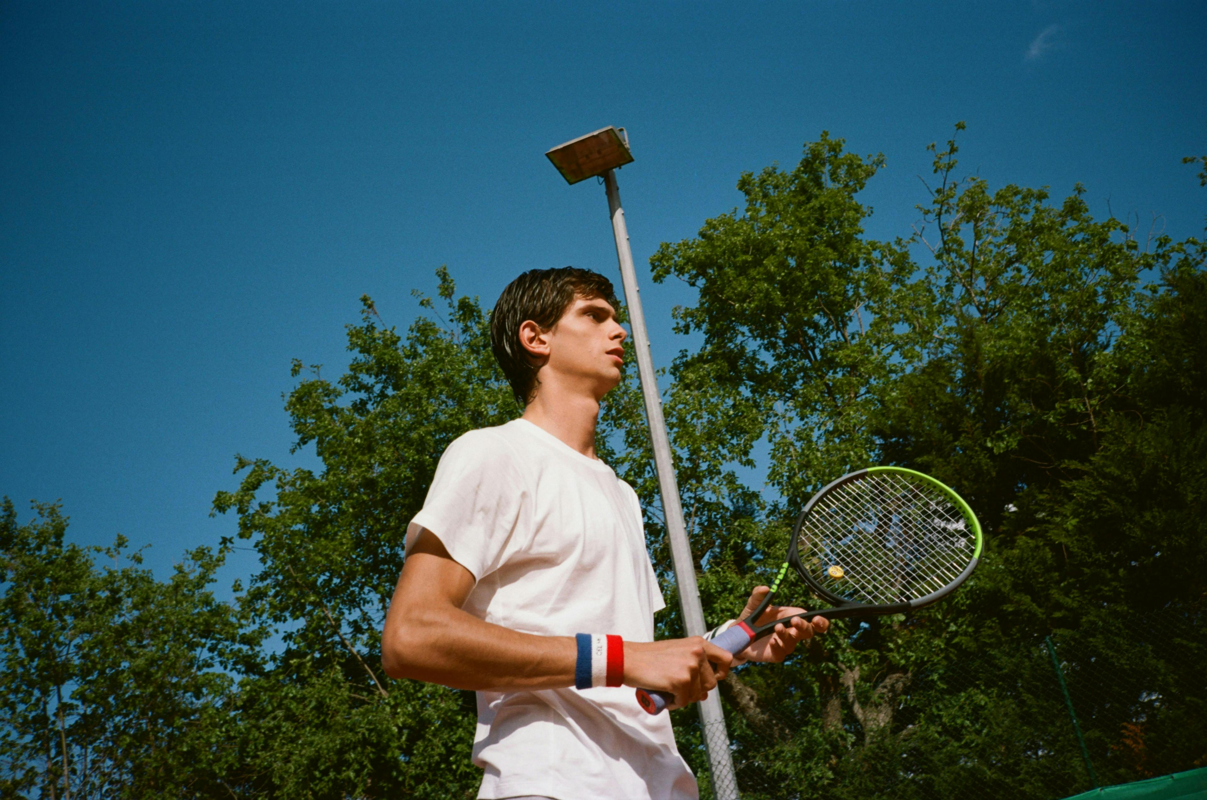 person human tennis racket racket sport sports clothing apparel