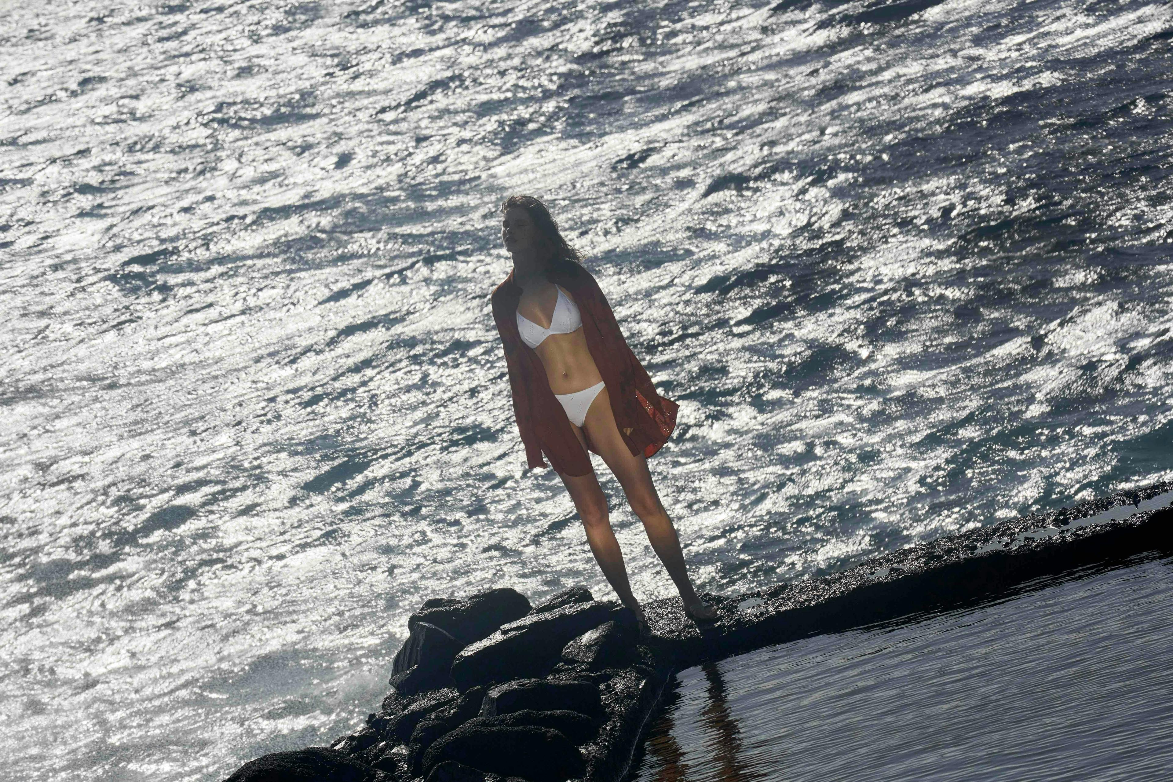 beachwear rock outdoors sea adult female person woman swimwear standing