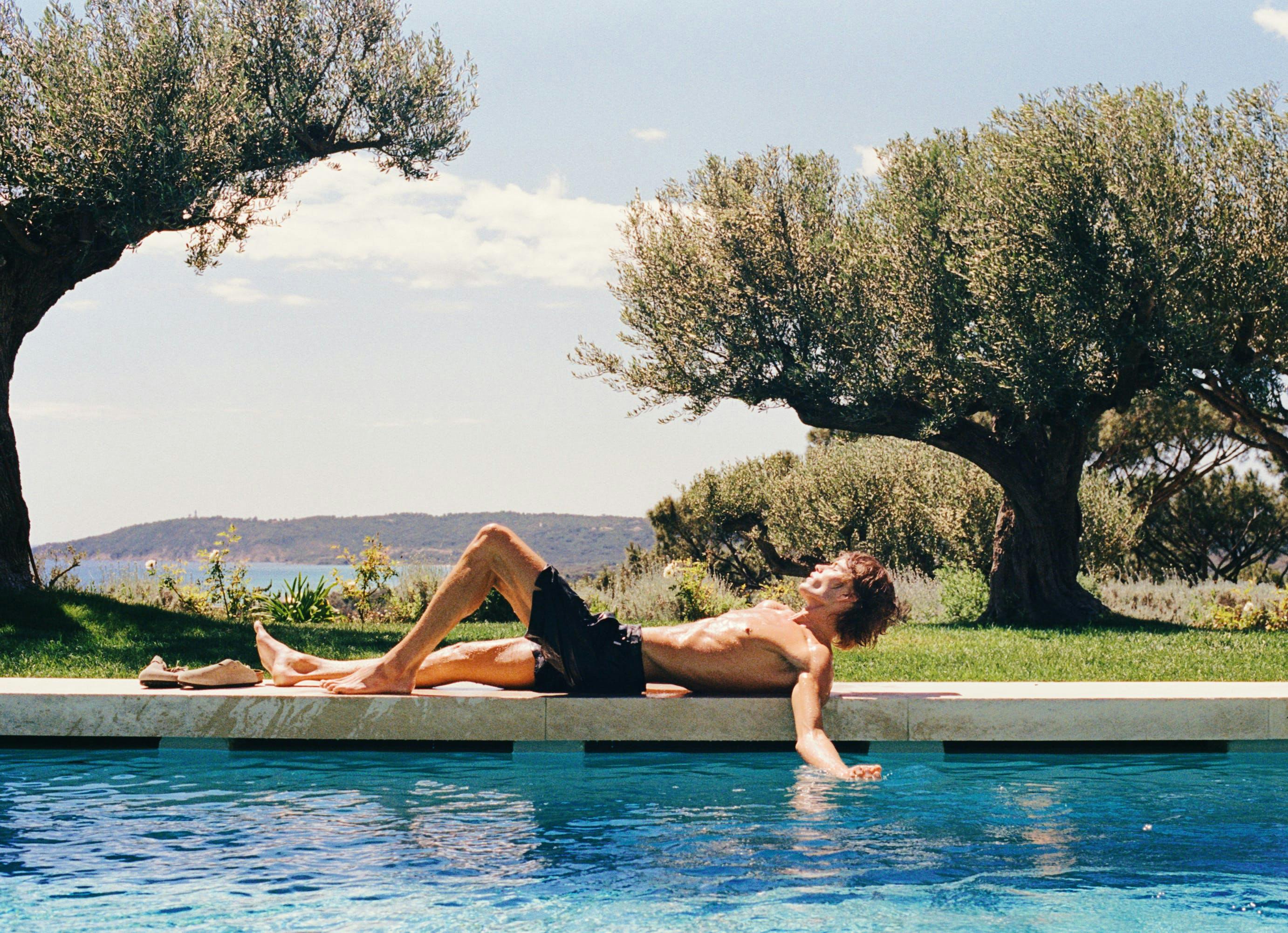 person sunbathing pool swimming pool water