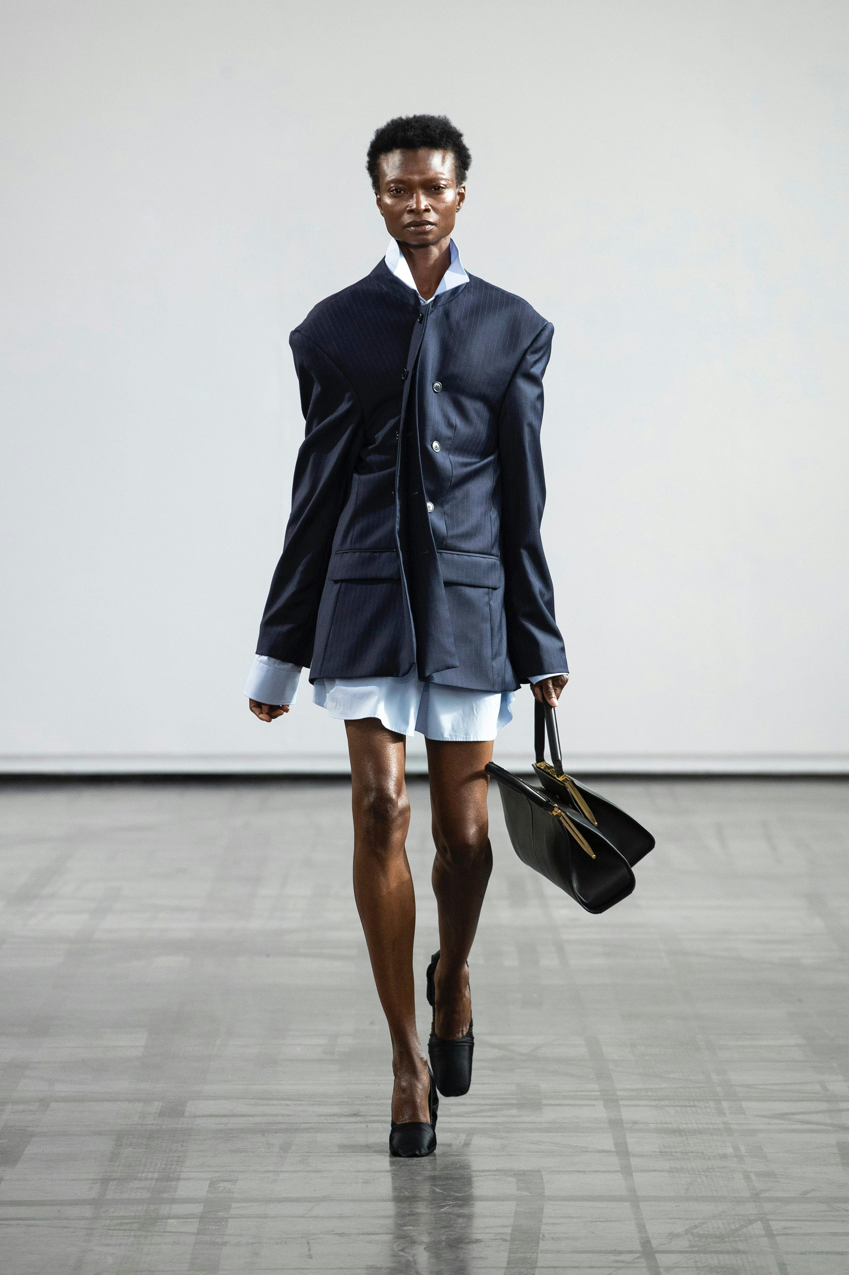 coat fashion adult male man person bag handbag long sleeve high heel