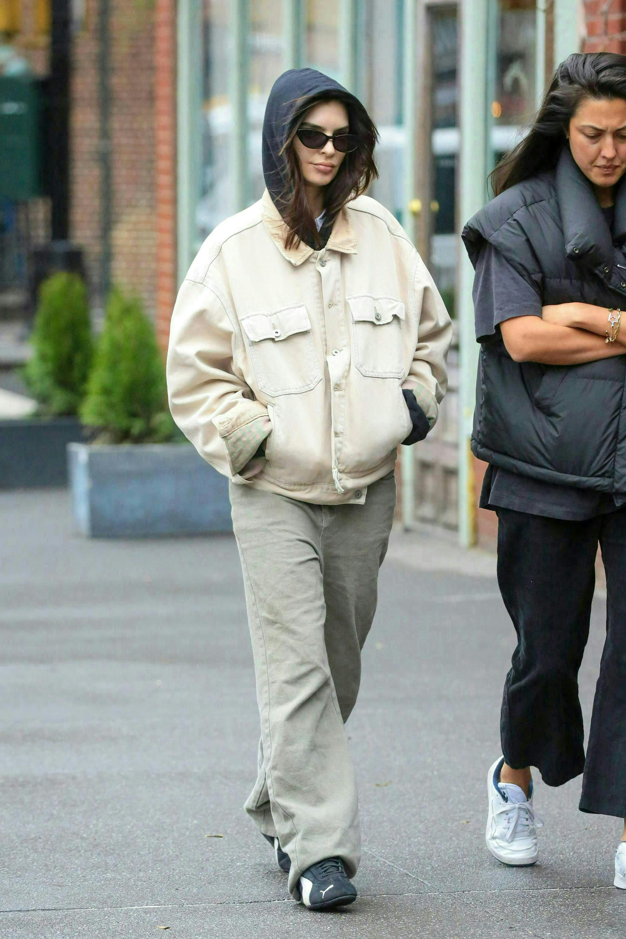 pedestrian person clothing pants walking adult female woman hoodie glove