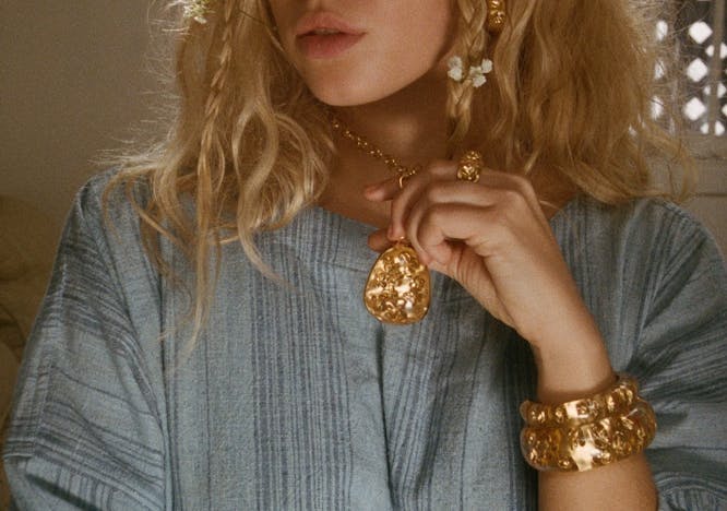 accessories blonde person jewelry blouse clothing locket pendant portrait necklace